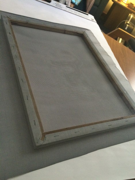 To make a deckle, we stapled a mesh screen to the frame.