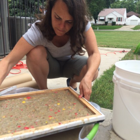 Using our homemade deckle, we collected the mixed pulp.